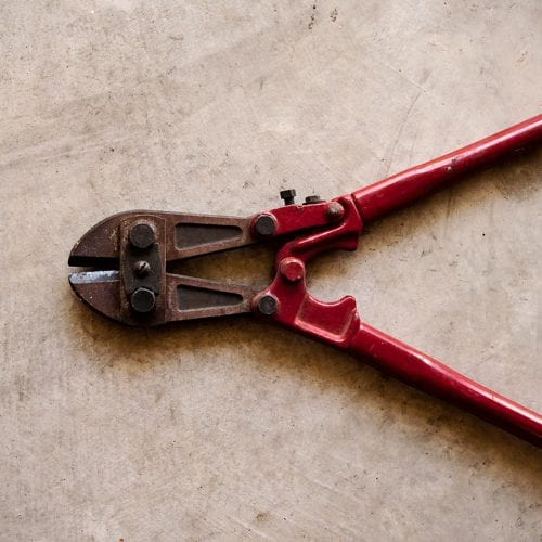 red bolt cutter on floor