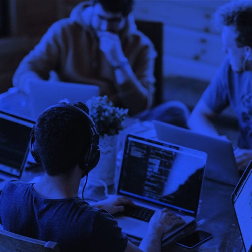 Men and women working on their laptops while appearing to solve a problem.