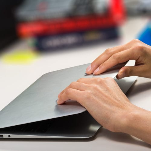 Close-up of a woman opening her laptop